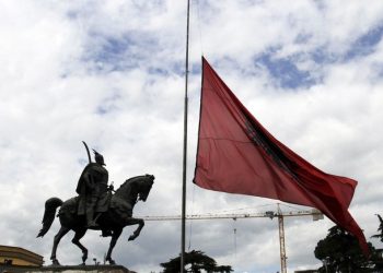 An Albanian national flag flies at half-mast in front of Albanian national hero George Kastriotis Skanderbeg on a national day of mourning in Tirana, May 22, 2012, after a bus crash took place on Monday in southern Albania. At least 12 Albanian university students and the driver of the bus were killed and 22 others injured when their bus plunged hundreds of feet into a ravine on Monday, police said.      REUTERS/Arben Celi (ALBANIA - Tags: DISASTER TRANSPORT)