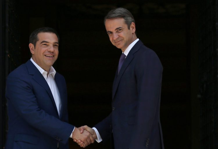 Newly-appointed Greek Prime Minister Kyriakos Mitsotakis shakes hands with outgoing Prime Minister Alexis Tsipras at the Maximos Mansion in Athens, Greece July 8, 2019. REUTERS/Costas Baltas