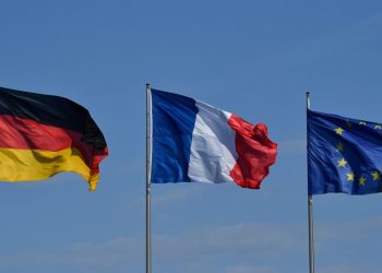 The German, French and European Union flags flutter in the wind at the Chancellery in Berlin on April 29, 2019 ahead of the West Balkans conference. - German Chancellor Angela Merkel and French President Emmanuel Macron are hosting the Western Balkans leaders and EU members Croatia and Slovenia hoping to reboot a dialogue between bitter foes Serbia and Kosovo over one of the Balkans' thorniest disputes. (Photo by John MACDOUGALL / AFP)