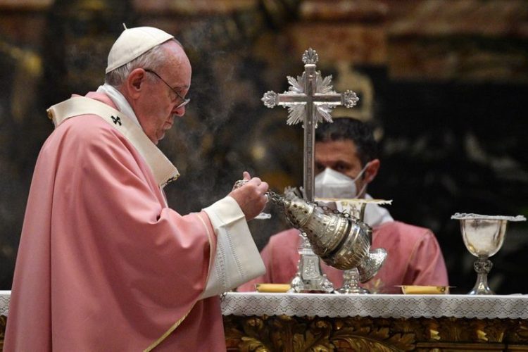 Pope Francis swings a thurible of incense around the altar at a mass to mark 500 years of Christianity in the Philippines, in St. Peter's Basilica at the Vatican, March 14, 2021. Tiziana Fabi/Pool via REUTERS