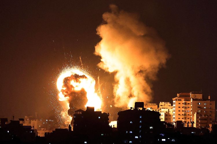 TOPSHOT - Fire billow from Israeli air strikes in the Gaza Strip, controlled by the Palestinian Islamist movement Hamas, on May 10, 2021. - Israel launched deadly air strikes on Gaza in response to a barrage of rockets fired by the Islamist movement Hamas amid spiralling violence sparked by unrest at Jerusalem's Al-Aqsa Mosque compound. (Photo by MAHMUD HAMS / AFP)