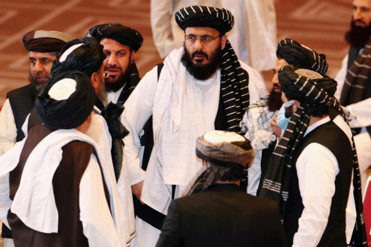 FILE PHOTO: Taliban delegates speak during talks between the Afghan government and Taliban insurgents in Doha, Qatar September 12, 2020. REUTERS/Ibraheem al Omari/File Photo/File Photo