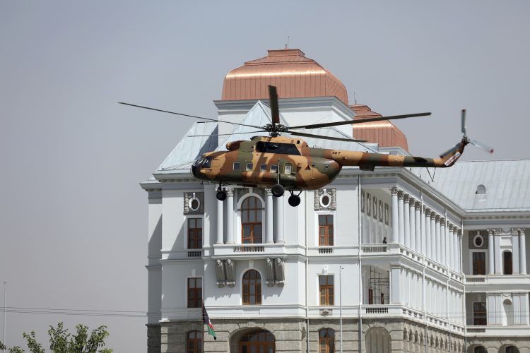 A helicopter carrying President Ashraf Ghani prepares to land at the Darul Aman Palace in Kabul, Afghanistan, Monday, Aug. 2, 2021. (AP Photo/Rahmat Gul)