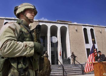 A U.S. marine, name not given, guards the entrance of the U.S. embassy in Kabul, prior to a news conference by Zalmy Khalilzad, U.S. Special Envoy in Afghanistan Sunday Feb. 24, 2002. (AP Photo/Lefteris Pitarakis)