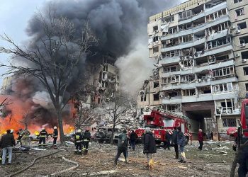 In this photo released by the Ukrainian Presidential Press Office, smoke rises after a Russian rocket hit a multistory building leaving many people under debris in Dnipro, Ukraine, Saturday, Jan. 14, 2023. (Ukrainian Presidential Press Office via AP)