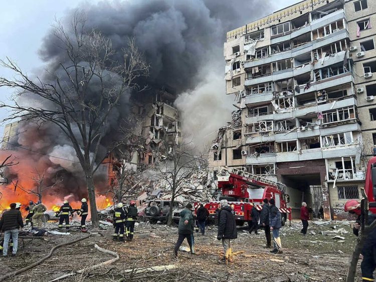 In this photo released by the Ukrainian Presidential Press Office, smoke rises after a Russian rocket hit a multistory building leaving many people under debris in Dnipro, Ukraine, Saturday, Jan. 14, 2023. (Ukrainian Presidential Press Office via AP)