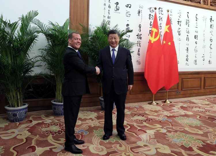 Deputy Chairman of Russia's Security Council Dmitry Medvedev and China's President Xi Jinping shake hands during a meeting in Beijing, China, December 21, 2022. Sputnik/Yekaterina Shtukina/Pool via REUTERS