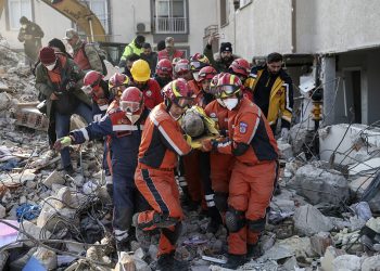 Rescue workers pull out a Syrian migrant from under the rubble of a destroyed building, in Antakya, southern Turkey, Sunday, Feb. 12, 2023. Six days after earthquakes in Syria and Turkey killed tens of thousands, sorrow and disbelief are turning to anger and tension over a sense that there has been an ineffective, unfair and disproportionate response to the historic disaster. (Cem Tekkesinoglu/DIA images via AP)