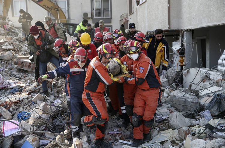 Rescue workers pull out a Syrian migrant from under the rubble of a destroyed building, in Antakya, southern Turkey, Sunday, Feb. 12, 2023. Six days after earthquakes in Syria and Turkey killed tens of thousands, sorrow and disbelief are turning to anger and tension over a sense that there has been an ineffective, unfair and disproportionate response to the historic disaster. (Cem Tekkesinoglu/DIA images via AP)