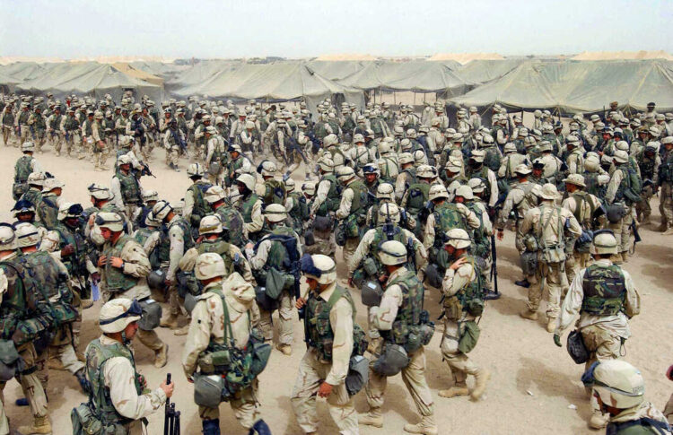 CAMP SHOUP, KUWAIT:  US Marines from the 2nd battalion/8 MAR, prepare themselves after receiving orders to cross the Iraqi border at Camp Shoup, northern Kuwait, 20 March 2003. US marines and army infantry have advanced 40 kilometers (20 miles) inside Iraq since storming across the Kuwaiti border overnight, a marine officer said early today.    AFP PHOTO/Eric FEFERBERG  (Photo credit should read ERIC FEFERBERG/AFP via Getty Images)