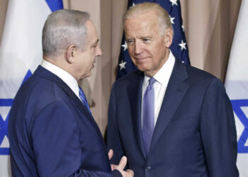 FILE - Israeli Prime Minister Benjamin Netanyahu, left, and Vice President Joe Biden talk prior to a meeting on the sidelines of the World Economic Forum in Davos, Switzerland, Jan. 21, 2016. President Joe Biden spoke Sunday, March 19, 2023, with Israeli Prime Minister Benjamin Netanyahu to “express concern” over his government’s planned overhaul of the country’s judicial system that has sparked widespread protests across Israel and to encourage compromise. (AP Photo/Michel Euler, File)