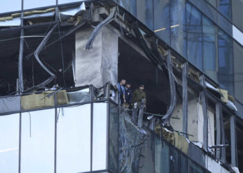 Investigators examine a damaged skyscraper in the "Moscow City" business district after a reported drone attack in Moscow, Russia, early Sunday, July 30, 2023. (AP Photo)