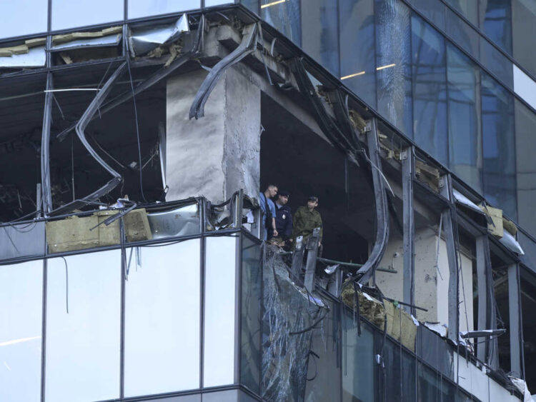 Investigators examine a damaged skyscraper in the "Moscow City" business district after a reported drone attack in Moscow, Russia, early Sunday, July 30, 2023. (AP Photo)
