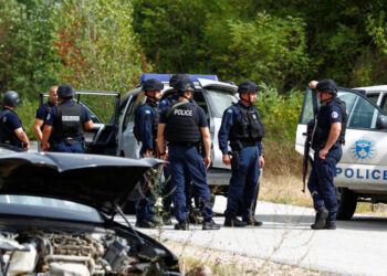 Police officers stand guard in the aftermath of a shooting, near the village of Zvecane, Kosovo September 24, 2023. REUTERS/Ognen Teofilovski