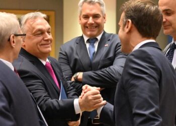 TOPSHOT - Hungary's Prime Minister Viktor Orban (CL) and France's President Emmanuel Macron (CR) shake hands ahead of a roundtable meeting of the European Council at the European headquarters in Brussels, on December 14, 2023. EU leaders are meeting in Brussels in what is seen as an opportunity to reaffirm the EU membership's perspective of the Western Balkans. The crunch summit in Brussels, which diplomats fear could drag on longer than the two days planned, comes as fears mount over Western backing for Ukraine nearly two years into Russia's war. (Photo by Miguel MEDINA / AFP)