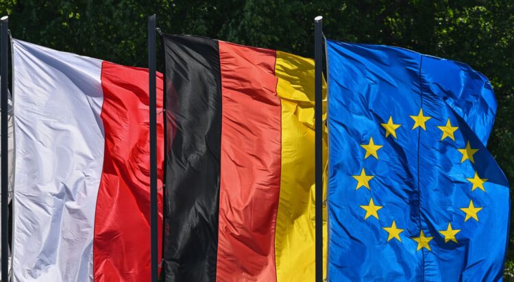 FILED - Flags of Poland, Germany and the EU: The connections between people in Germany and Poland are to become even closer on the initiative of several German federal states. Photo: Patrick Pleul/dpa