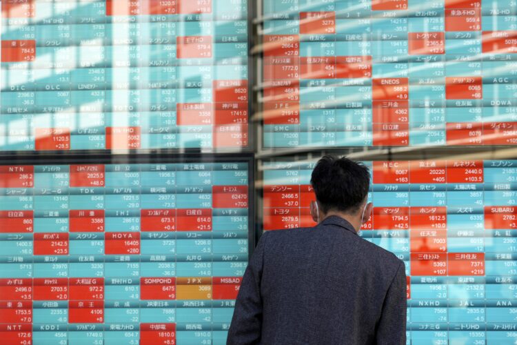 A person watches an electronic stock board showing Japan's Nikkei 225 index at a securities firm Thursday, Nov. 16, 2023, in Tokyo. (AP Photo/Eugene Hoshiko)