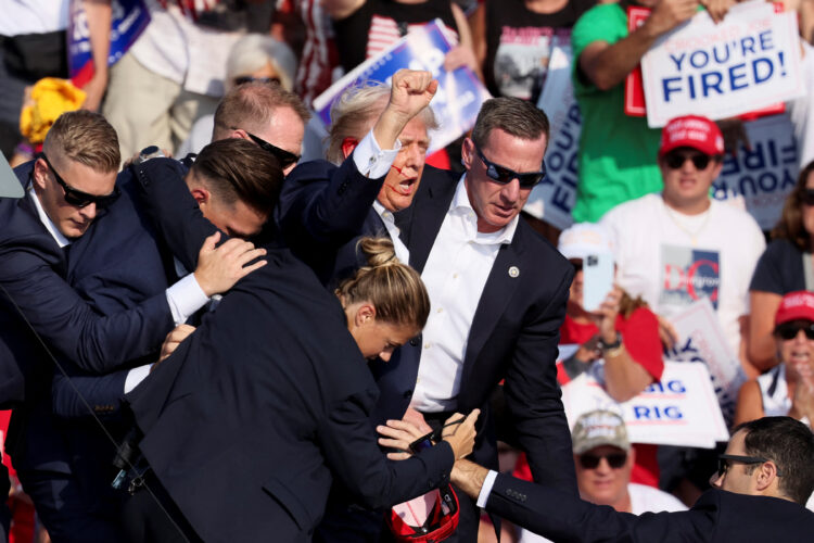 Republican presidential candidate and former U.S. President Donald Trump is assisted by U.S. Secret Service personnel after gunfire rang out during a campaign rally at the Butler Farm Show in Butler, Pennsylvania, U.S., July 13, 2024. REUTERS/Brendan McDermid