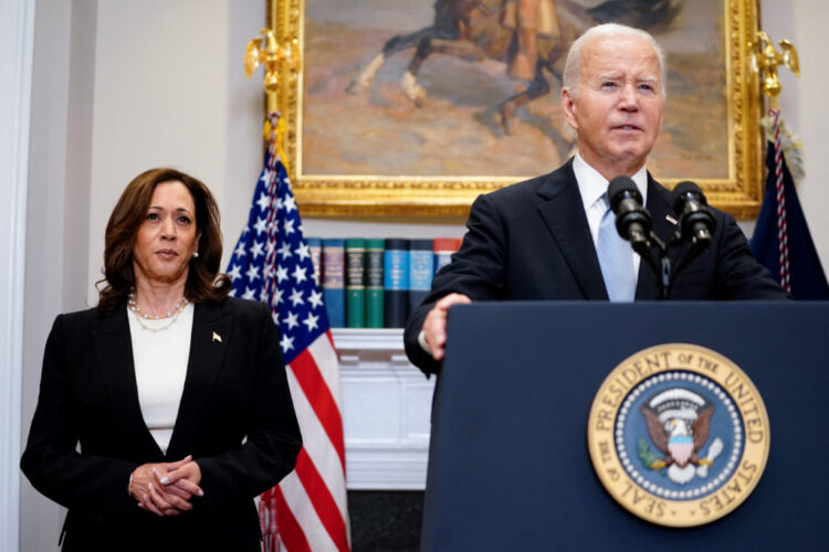 U.S. President Joe Biden speaks next to Vice President Kamala Harris as he delivers a statement a day after Republican challenger Donald Trump was shot at a campaign rally, during brief remarks at the White House in Washington, U.S., July 14, 2024. REUTERS/Nathan Howard