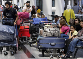 Travelers sit next to their luggage at the departure terminal of the Rafik Hariri International Airport in Beirut, Lebanon, Tuesday, Aug. 20, 2019. Lebanese Prime Minister Saad Hariri inaugurated new measures at the country's main international airport that aim to end crowding at the departure lounge. Passengers will check in their luggage that will later be scanned by the sophisticated scanners. (AP Photo/Bilal Hussein)/OTK/19232458530751//1908201510