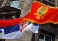 Flags of Serbia (L) and Montenegro (R) fly in front of the Ministry of Foreign affairs building in Belgrade, 22 June 2006. Serbia and Montenegro officially established diplomatic relations on Thursday, setting the seal on the tiny Balkan state's peaceful split from decades of union with Belgrade. Serbian Foreign Minister Vuk Draskovic and his Montenegrin counterpart Miodrag Vlahovic signed a protocol on establishing diplomatic ties between the two republics. AFP PHOTO / ANDREJ ISAKOVIC (Photo by ANDREJ ISAKOVIC / AFP)