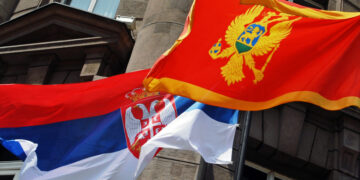 Flags of Serbia (L) and Montenegro (R) fly in front of the Ministry of Foreign affairs building in Belgrade, 22 June 2006. Serbia and Montenegro officially established diplomatic relations on Thursday, setting the seal on the tiny Balkan state's peaceful split from decades of union with Belgrade. Serbian Foreign Minister Vuk Draskovic and his Montenegrin counterpart Miodrag Vlahovic signed a protocol on establishing diplomatic ties between the two republics. AFP PHOTO / ANDREJ ISAKOVIC (Photo by ANDREJ ISAKOVIC / AFP)