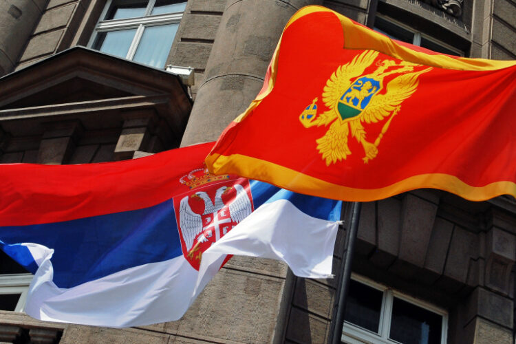 Flags of Serbia (L) and Montenegro (R) fly in front of the Ministry of Foreign affairs building in Belgrade, 22 June 2006. Serbia and Montenegro officially established diplomatic relations on Thursday, setting the seal on the tiny Balkan state's peaceful split from decades of union with Belgrade. Serbian Foreign Minister Vuk Draskovic and his Montenegrin counterpart Miodrag Vlahovic signed a protocol on establishing diplomatic ties between the two republics. AFP PHOTO / ANDREJ ISAKOVIC (Photo by ANDREJ ISAKOVIC / AFP)