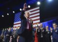 Republican presidential nominee former President Donald Trump waves as he walks with former first lady Melania Trump at an election night watch party at the Palm Beach Convention Center, Wednesday, Nov. 6, 2024, in West Palm Beach, Fla. (AP Photo/Evan Vucci)