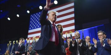 Republican presidential nominee former President Donald Trump waves as he walks with former first lady Melania Trump at an election night watch party at the Palm Beach Convention Center, Wednesday, Nov. 6, 2024, in West Palm Beach, Fla. (AP Photo/Evan Vucci)