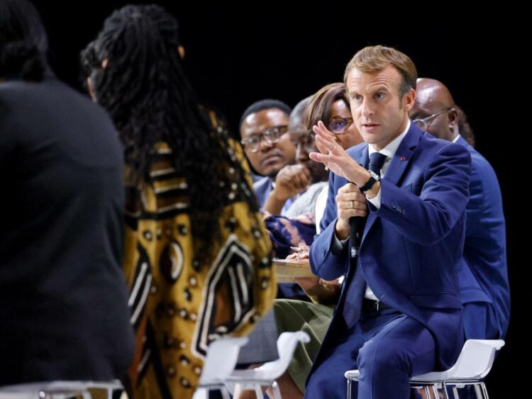 French President Emmanuel Macron speaks during the plenary session of the "Africa-France Summit" gathering some 3000 Africa continent entrepreneurs, artists or sporting figures in Montpellier, southern France, on October 8, 2021. - No Africa head of state has been invited to the summit, which is being held in a delicate context while the influence of France in its former precinct is increasingly disputed, particularly by Russia, and because Paris is in open crisis with two of its former colonies, Mali and Algeria. (Photo by Ludovic MARIN / AFP)