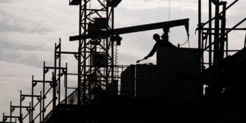 FILED - A construction worker is working on a building site. Photo: Monika Skolimowska/dpa