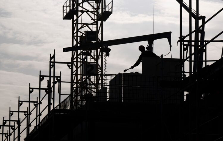 FILED - A construction worker is working on a building site. Photo: Monika Skolimowska/dpa