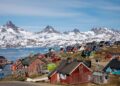 FILE PHOTO: Snow covered mountains rise above the harbour and town of Tasiilaq, Greenland, June 15, 2018. REUTERS/Lucas Jackson/File Photo