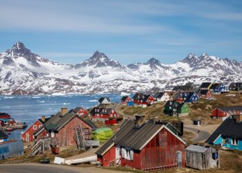 FILE PHOTO: Snow covered mountains rise above the harbour and town of Tasiilaq, Greenland, June 15, 2018. REUTERS/Lucas Jackson/File Photo