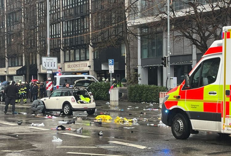 Police officers investigate a car near a crime scene in Munich city center, where a vehicle drove into a group of people. Photo: Christoph Trost/dpa