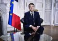 This photograph shows a television screen broadcasting French President Emmanuel Macron delivering his New Year wishes during an address to the nation from the Elysee Palace, in Paris, on December 31, 2020. (Photo by STEPHANE DE SAKUTIN / AFP)